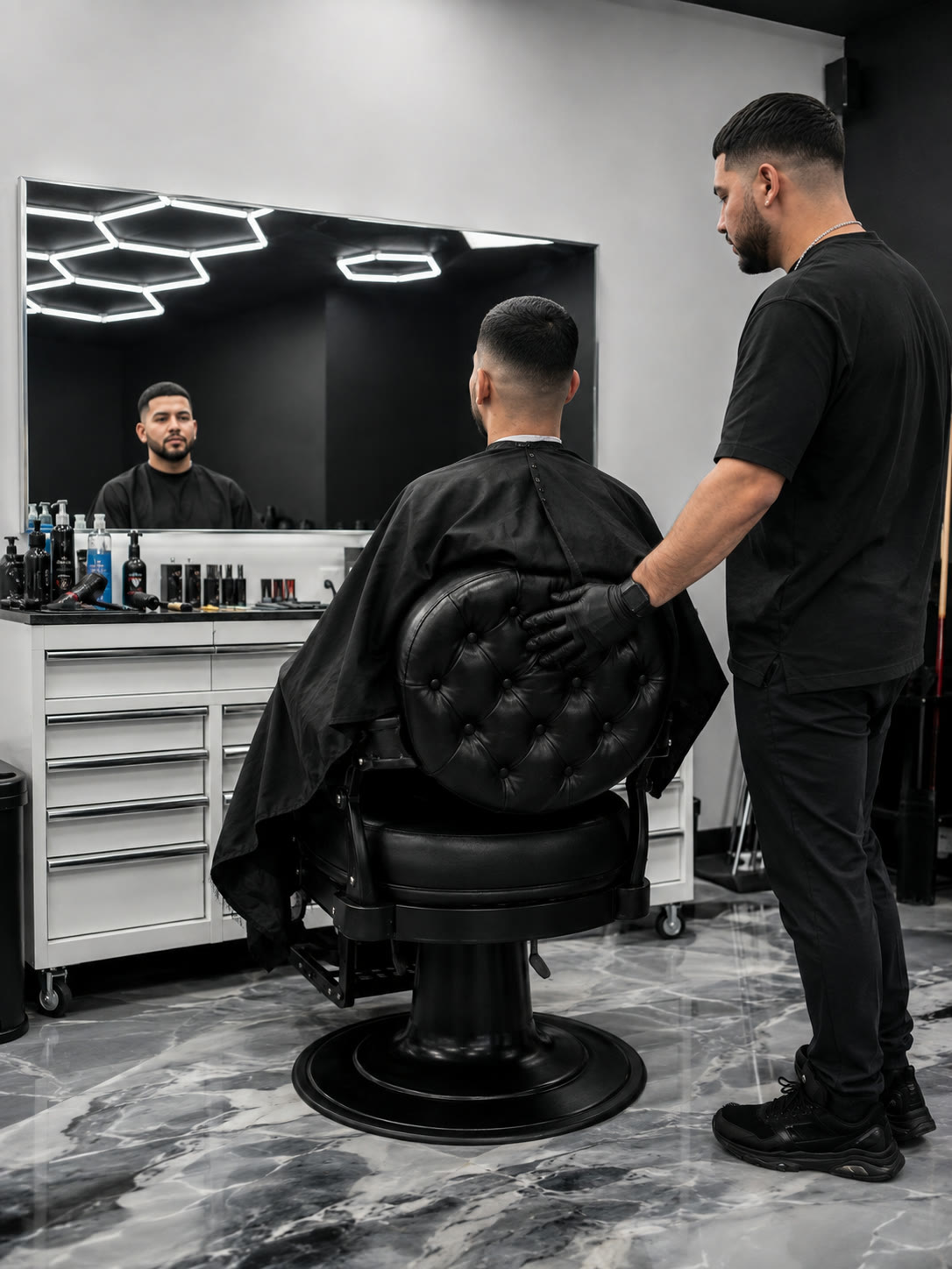 A barber turns the chair toward the mirror as a client checks his finished fade.